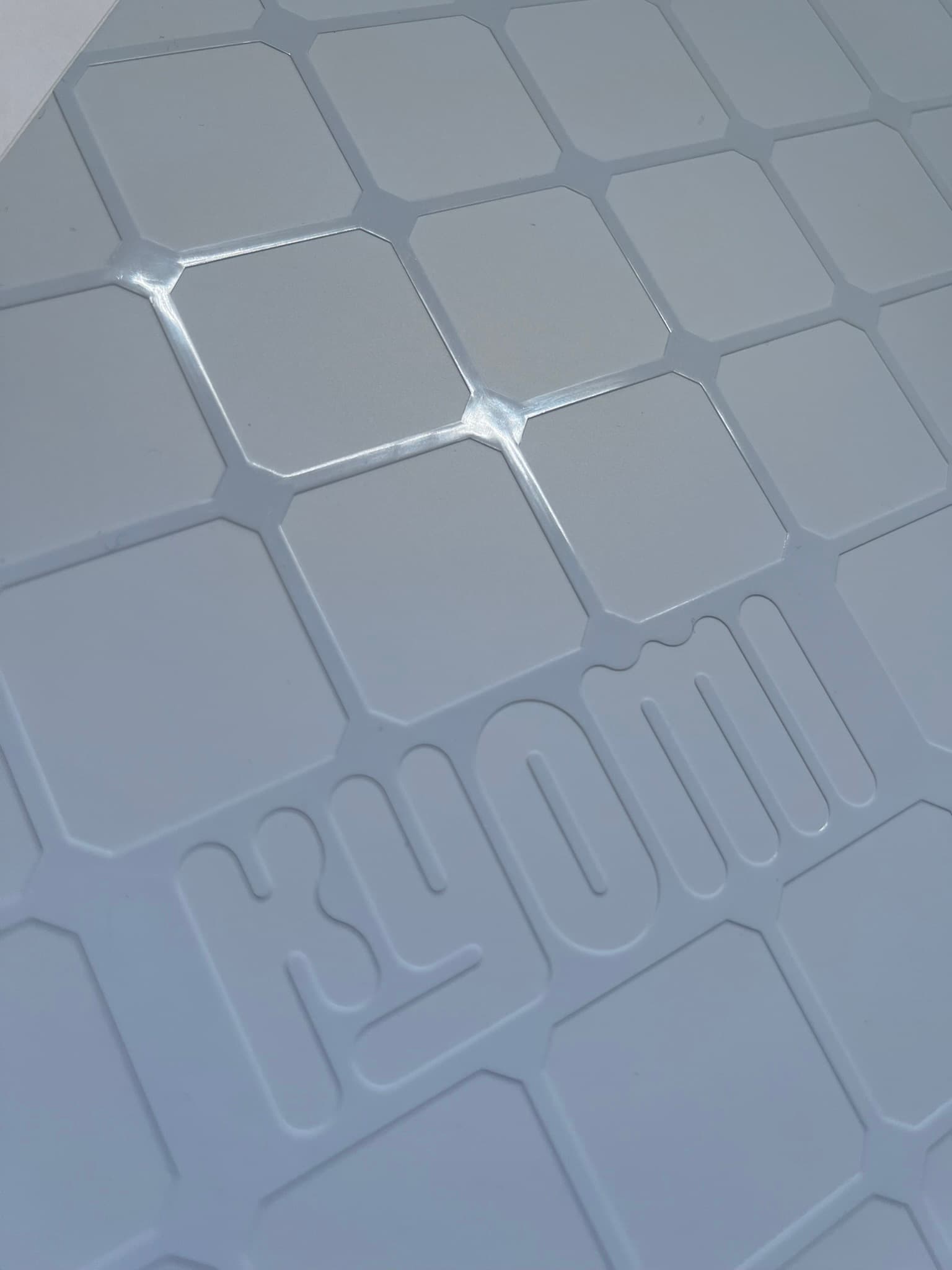 Custom silicone grid base with embossed Kyomi branding